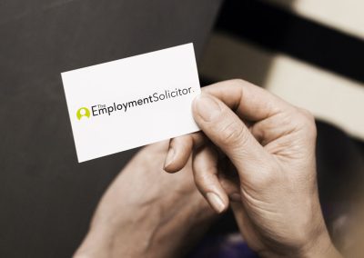 a female hand holding an Employment Solicitor business card