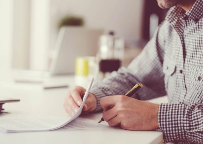 a man signing a settlement agreement