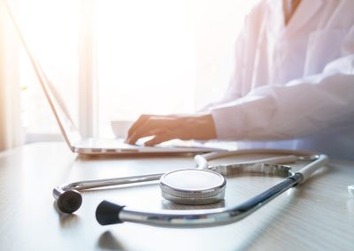 doctor typing out prescription
